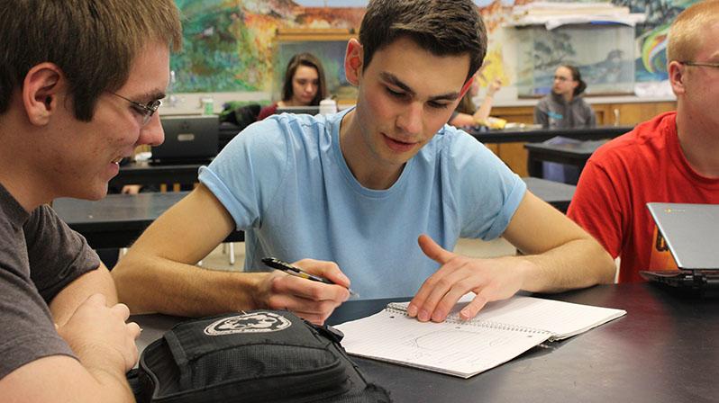     Senior Nick Christopherson works diligently with Senior Jimmy Uthe  in AP environmental science