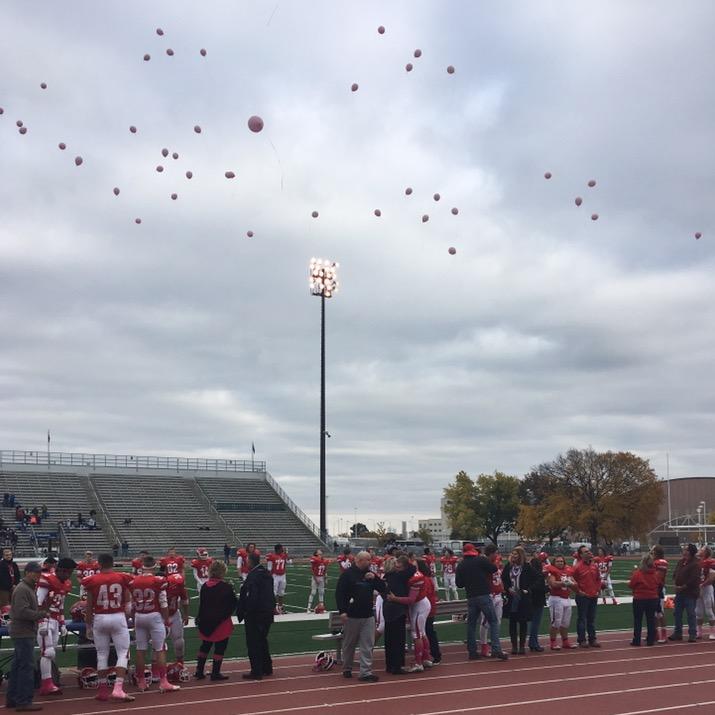 On+senior+night%2C++the+Lincoln+Patriot+football+players+released+pink+balloons+in+honor+of+Payton+Sudengas+mother+who+recently+passed+away+from+breast+cancer.