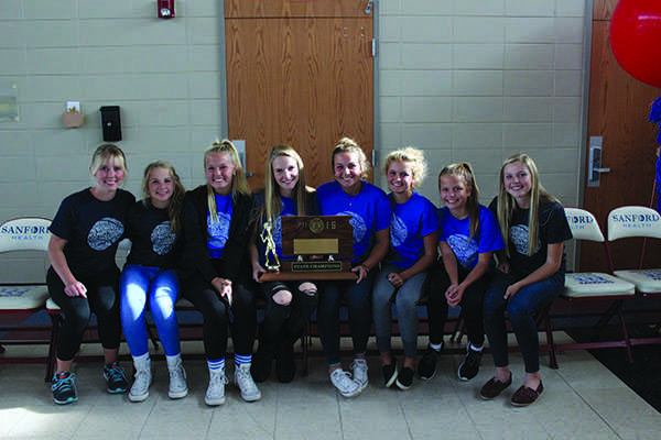 The LHS girls tennis team celebrates their state championship title at their welcome home party.