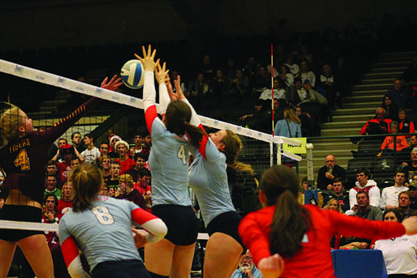 LHS senior Maddie Barness and junior Allie Engels go up to block during their first round game of the state volleyball tournament against Harrisburg.
