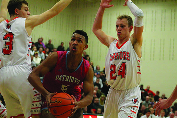 Dillon Barrow helps the Patriots battle against the Warriors by scoring a layup with two defenders on him in the fourth quarter.