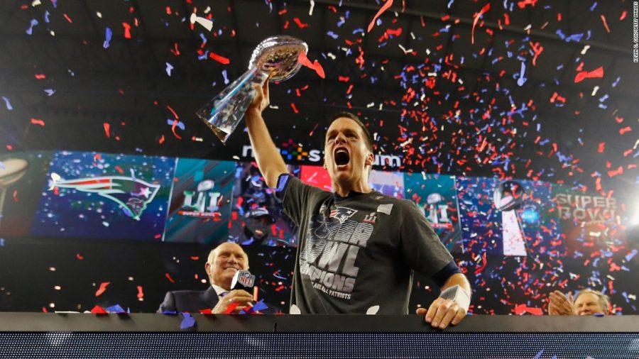 Patriots quarterback Tom Brady holds up the Vince Lombardi Trophy, celebrating his fifth Super Bowl win. 