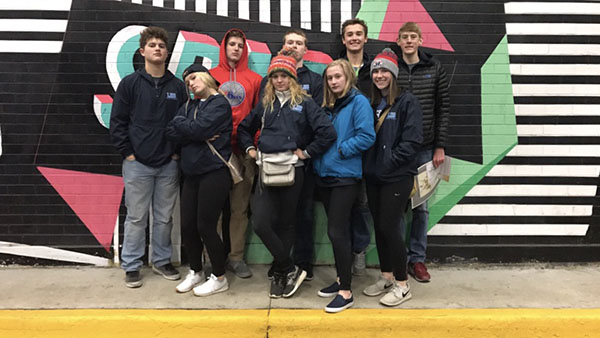 Junior Student Council members stand in front of a mural in Washington D.C.