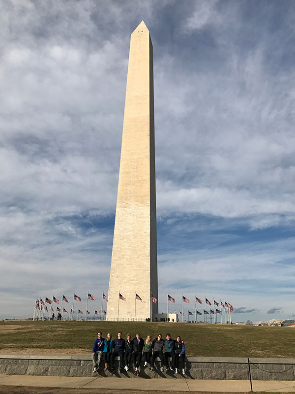 Junior Student Council members stand in front of the Washington Monument while on a school sponsored trip 
