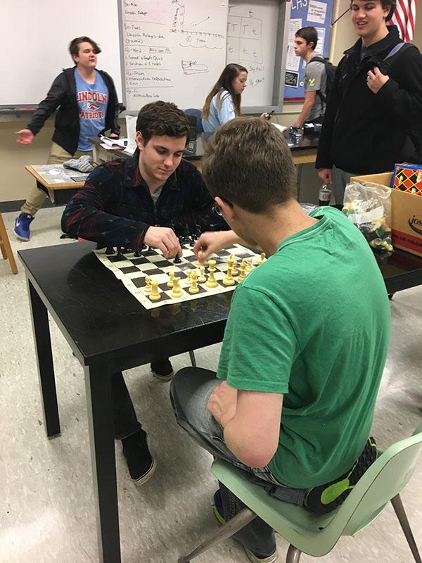 Chess Club members Blake Hustrulid and Dylan Steinwand engage in a competitive game during their weekly meeting.