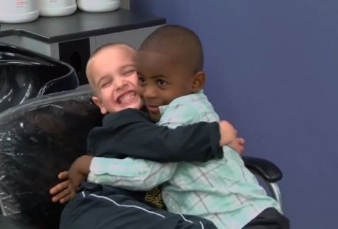 Best friends Jax, left, and Reddy, right, hug and laugh after Jax got a haircut similar to his friend's. 