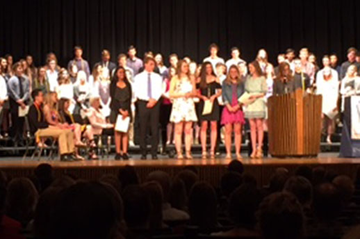 Past and current NHS officers stand in front of the new NHS inductees at the NHS ceremony on May 24.