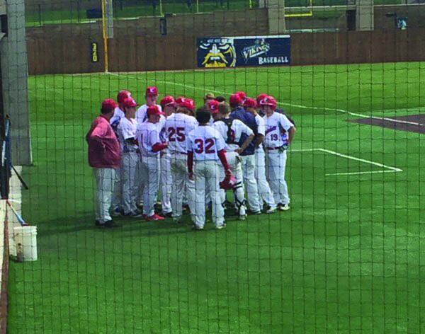 The LHS baseball team comes together in a huddle during their region game against Harrisburg.