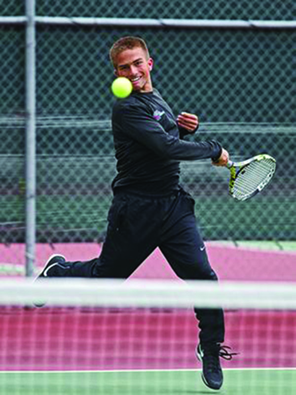 University of Minnesota tennis commit, Kaleb Dobbs returns the ball during the state tournament in Sioux Falls. 