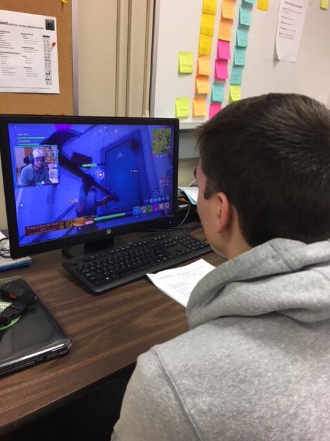 A LHS student studies YouTuber Ali-As gameplay, looking intently for strategies.