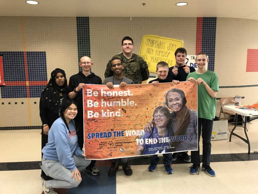 Rise students, Sado Ali,
Destiny Saengkio, 
Alex Rust, Antonio Humann, Lane Zufelt,
Jack Salestrom and
Noah Epling hold up the poster that many LHS students signed to pledge not using the R word. The group had a table set up in the lunchroom during lunch and handed out bracelets to students who were eating. 
Austin Farr (green shirt)