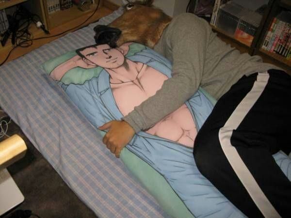Anonymous man wearing a horse mask snuggles with his beloved body pillow on a blue mattress