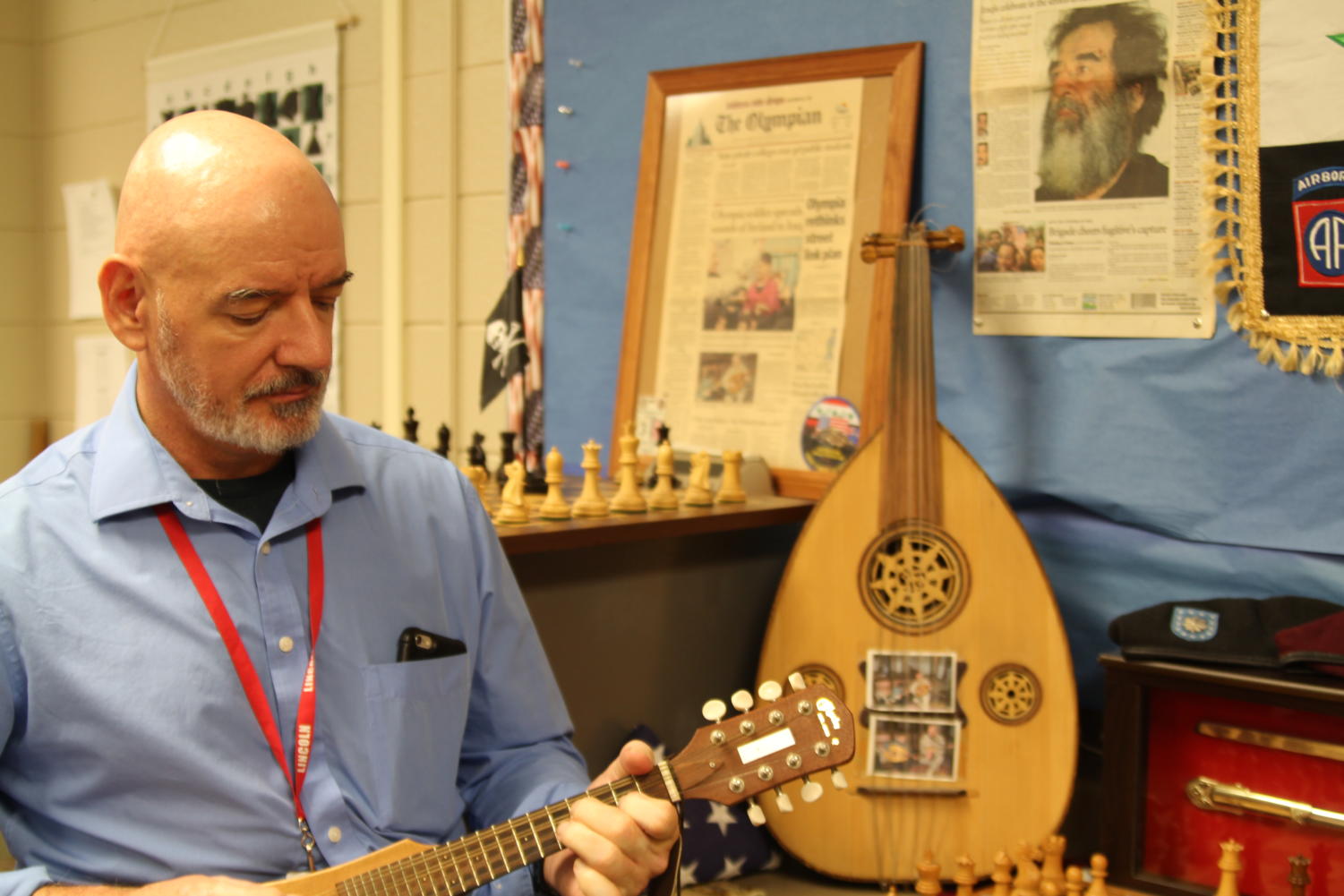 Tolle playing his backpack mandolin that he brought with him to many of the countries while he served.