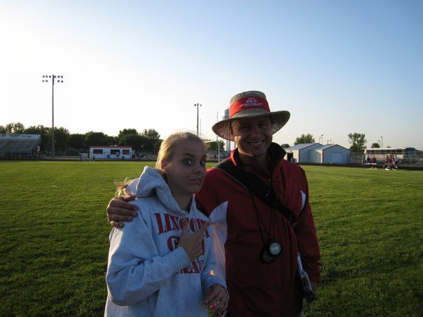 Palmer poses with the head track coach Jarovski during a high school track meet she competed in.