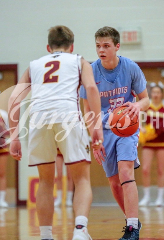 Junior Sam Fawcett brings the ball up the court as the point guard against one of the inter-city rivals, RHS.