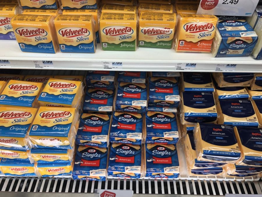 A wall of artificial cheese is a common sight at almost all grocery stores.