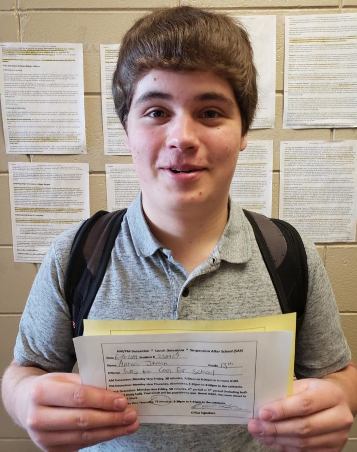 Senior Aaron Johnson receive a detention slip from the office.  