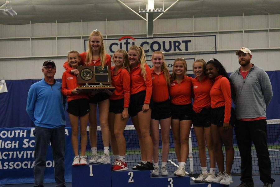 The LHS girls tennis team poses for pictures after claiming its fourth straight State title.