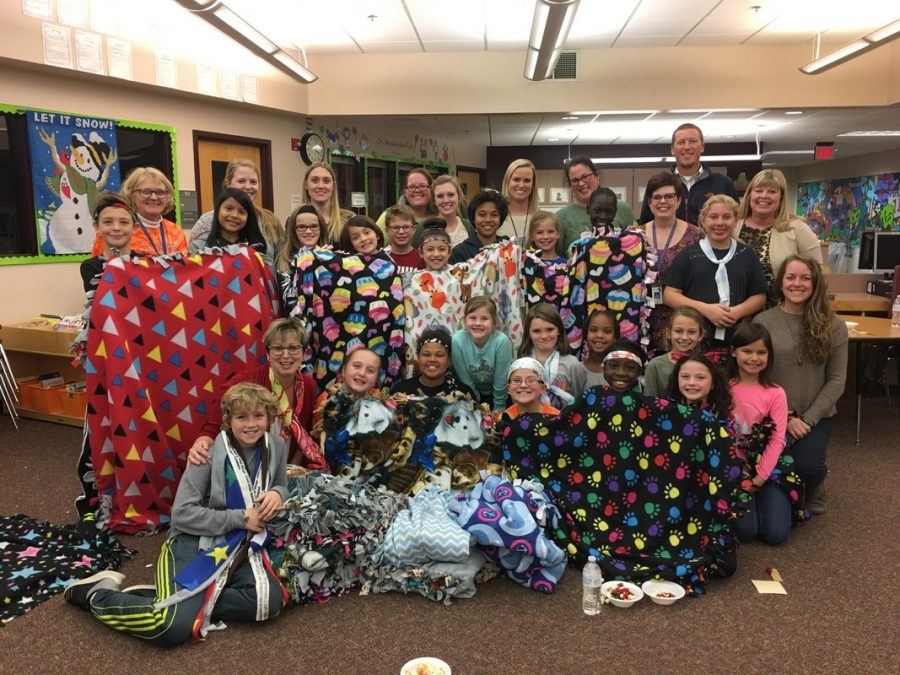 Students receiving blankets from Project Warm Up. Students from LHS spend time creating the blanket to give to people in need. 