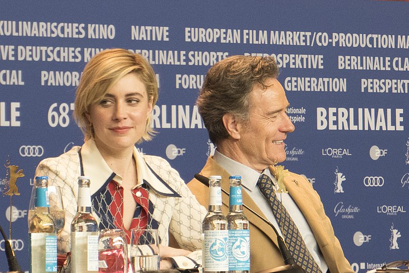 Gerwig and her costar Bryan Cranston at an Isle of Dogs press conference, a film for which she voiced the character of Tracy Walker.