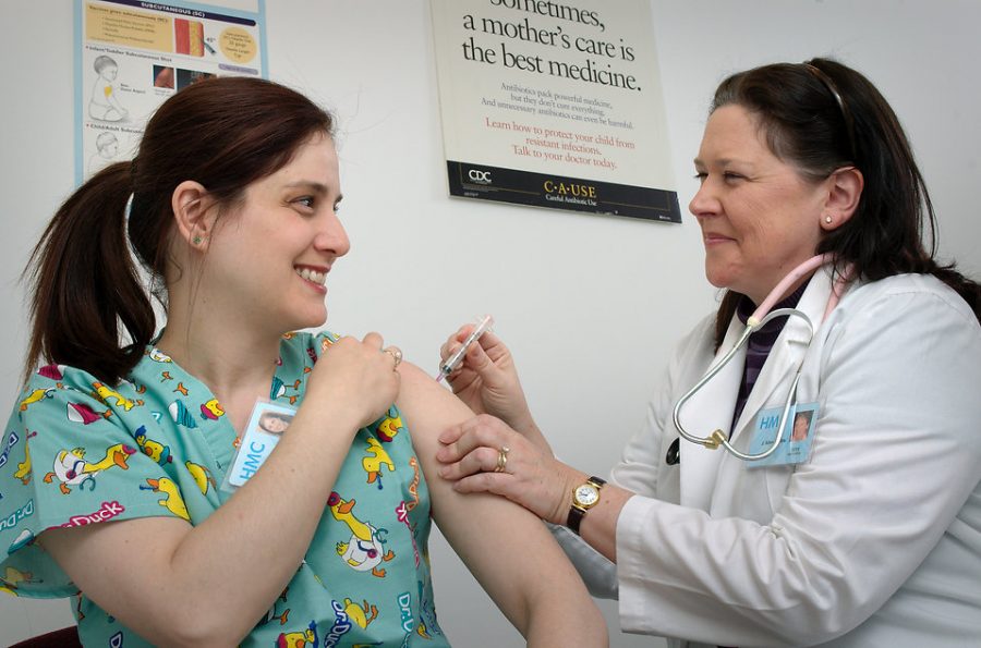 A female citizen receiving the Flu vaccine to protect herself against the illness.
