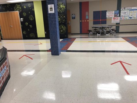 Red tape has been placed to direct students to their classes. Signs have also been placed to help the flow of traffic.