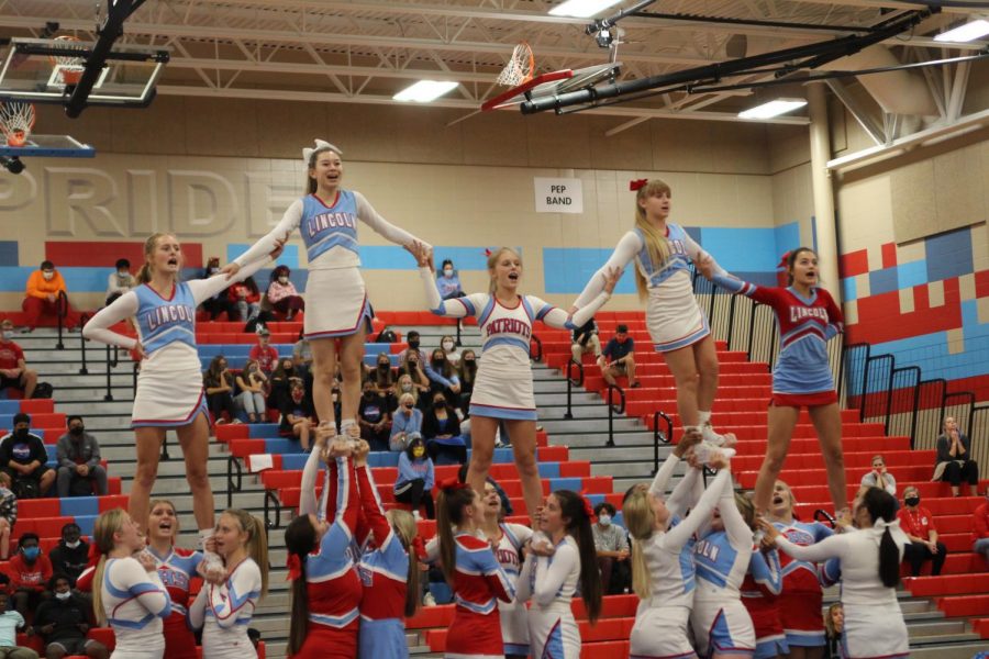The cheer team performs their routine.