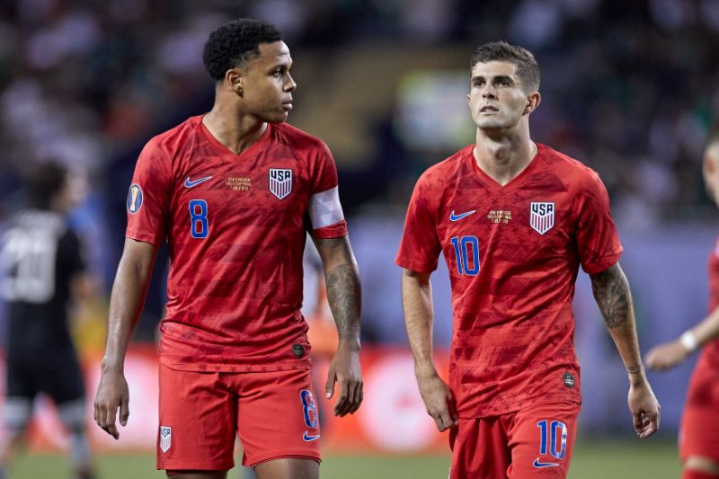 Young stars Christian Pulisic and Weston Mckennie walk off the field together after a CONCAF game