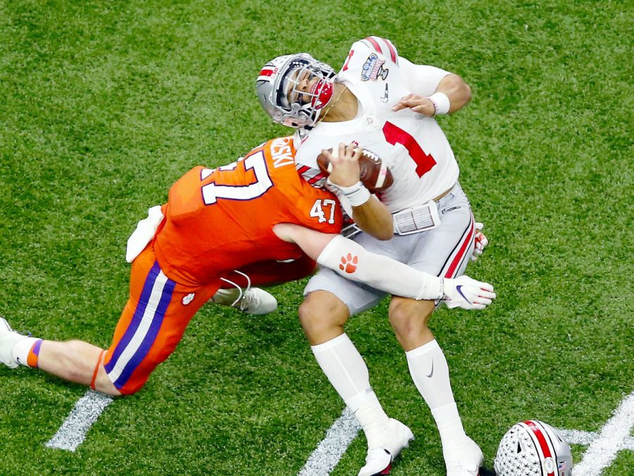 Justin Fields getting cracked in the back by Clemson linebacker.