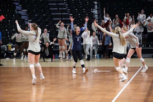 The Varsity volleyball team at the Monument this past weekend celebrating on the court. 