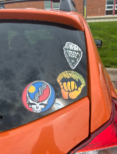 The stickers on this car show that this person has a love for heavy metal bands and supporting their local community.