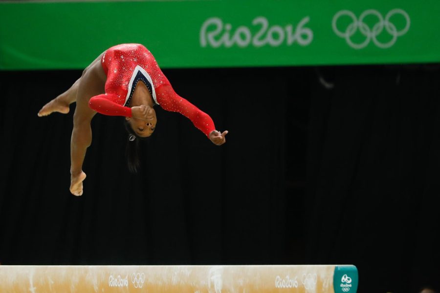 Simone+Biles+performing+on+the+balance+beam+during+the+2016+Rio+de+Janeiro+Olympics.++