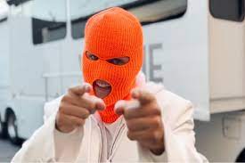 Justin Bieber in his orange ski mask as he ran around set filming I Feel Funny.