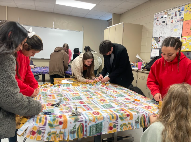 Members of the LHS National Honors Society meet to make blankets for Project Warm-Up. 