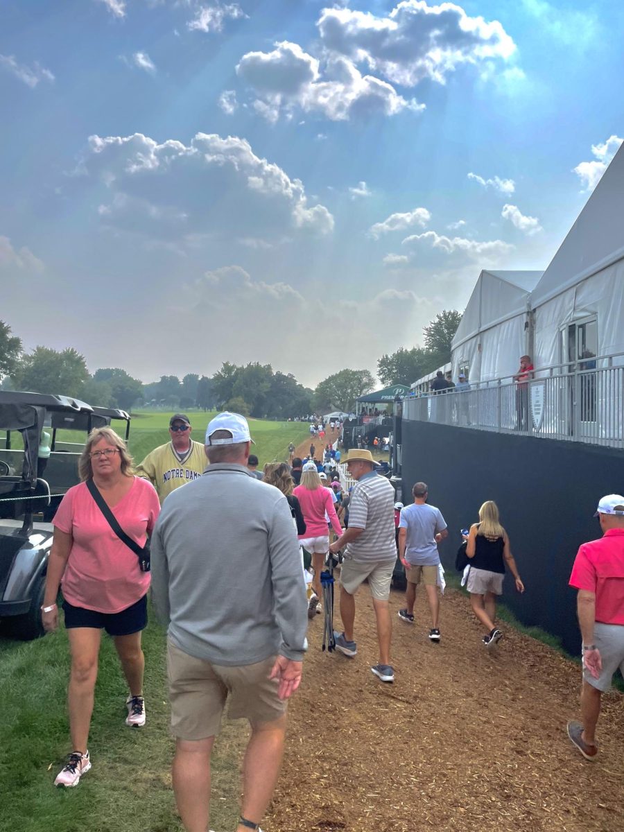 Viewers walking from hole to hole between the food trucks during the Sanford International held at the Minnehaha Country Club.