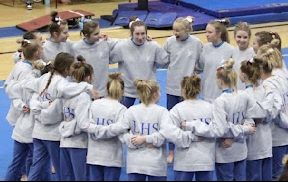 The LHS gymnastics team having a pep talk before they compete.
