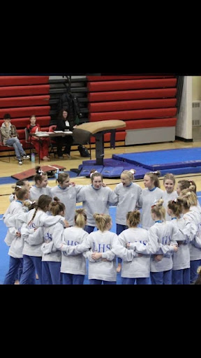 The LHS gymnastics team having a pep talk before they compete.