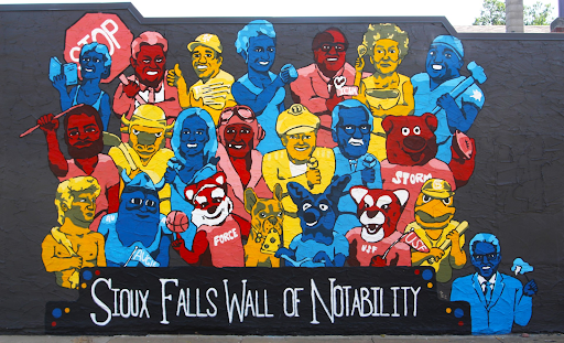 Sunnys Pizzerias Wall of Notability mural depicts 22 local celebrities who have left their mark on Sioux Falls.