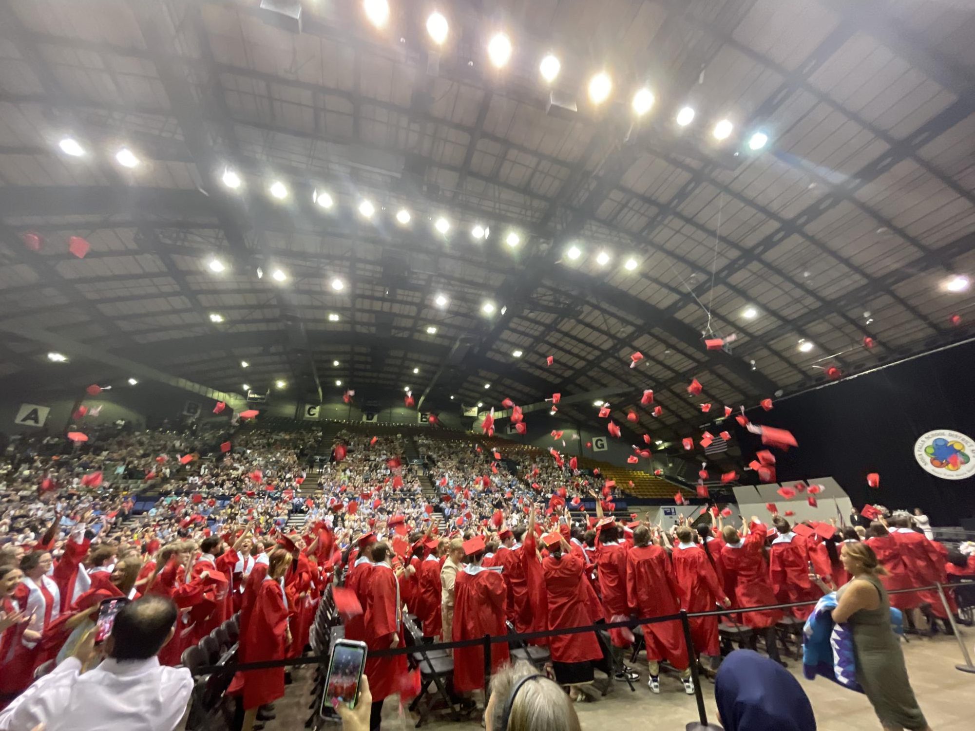 The class of 2023 throwing their graduation caps after they walked the stage at the Denny Sanford Premier Center.