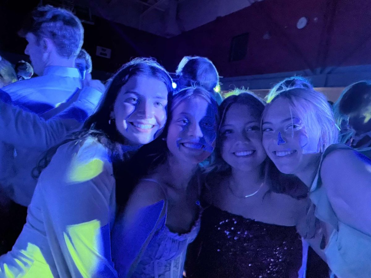 Under the LED spotlights on the dance floor at LHS, Statesman staff members Ellen Merkley, Hazel Hughes, Clara Binstock and I took a selfie during the last high school formal for three out of four of us.