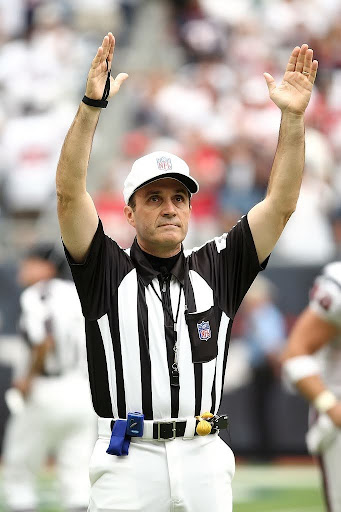 A professional NFL referee signaling that a touchdown was scored.
