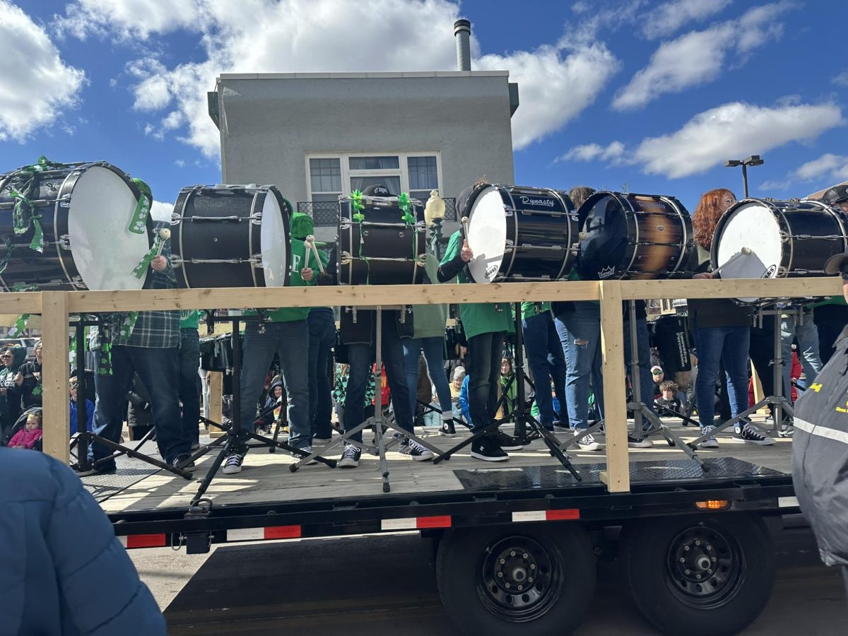 Groove, a youth percussion academy, performs for the parade viewers in festive St. Patrick’s Day outfits. 
