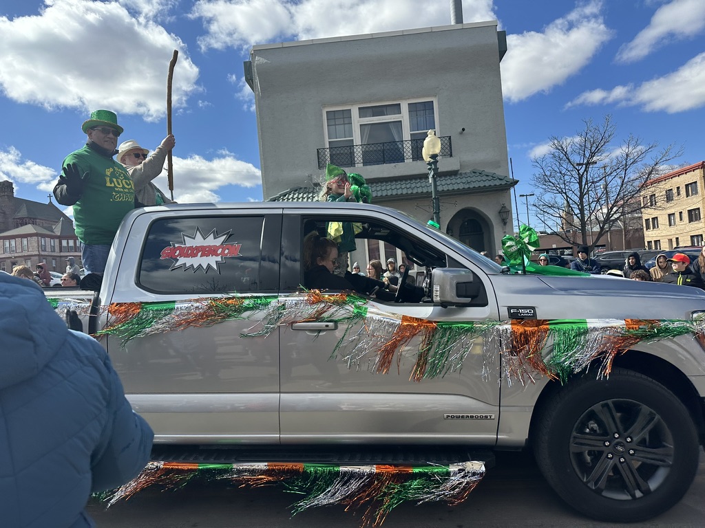 The Supercon float, proudly decorated with Irish colors, rides down Phillips Avenue. 
