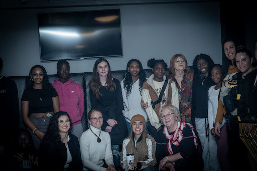 A group picture of all the students and mentors after a successful fashion show event.
