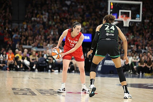 Clark sizing up Minnesota Lynx MVP candidate Napheesa Collier at Target Center.
