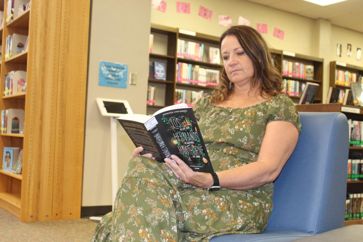 Mary Peters is engaging in knowledge through reading at the LHS library. 
