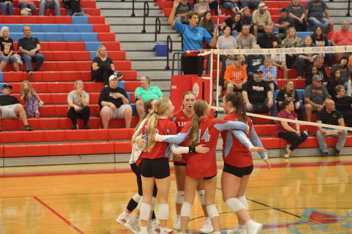 JV team huddle after winning an important point.