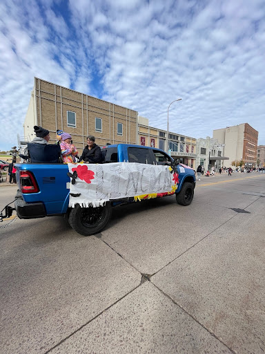 Casey drives the LHS banner across Phillips Ave, and LHS donors in the truck bed throw candy to attendees of the parade.