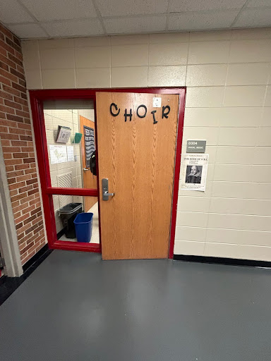 The choir door, slightly agar, waiting for an innocent person to pass.