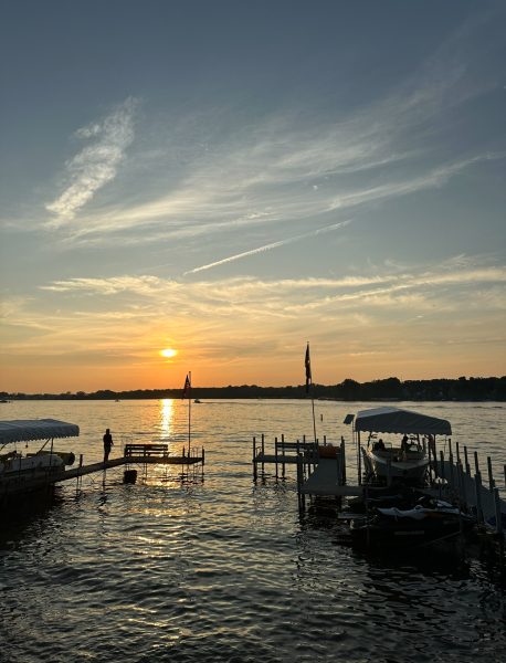 Sunset over the water in Lake Okoboji during the heat of July.